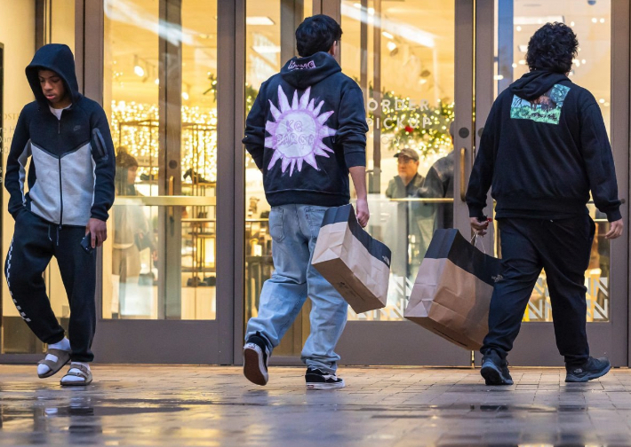 Customers carrying shopping bags through the mall